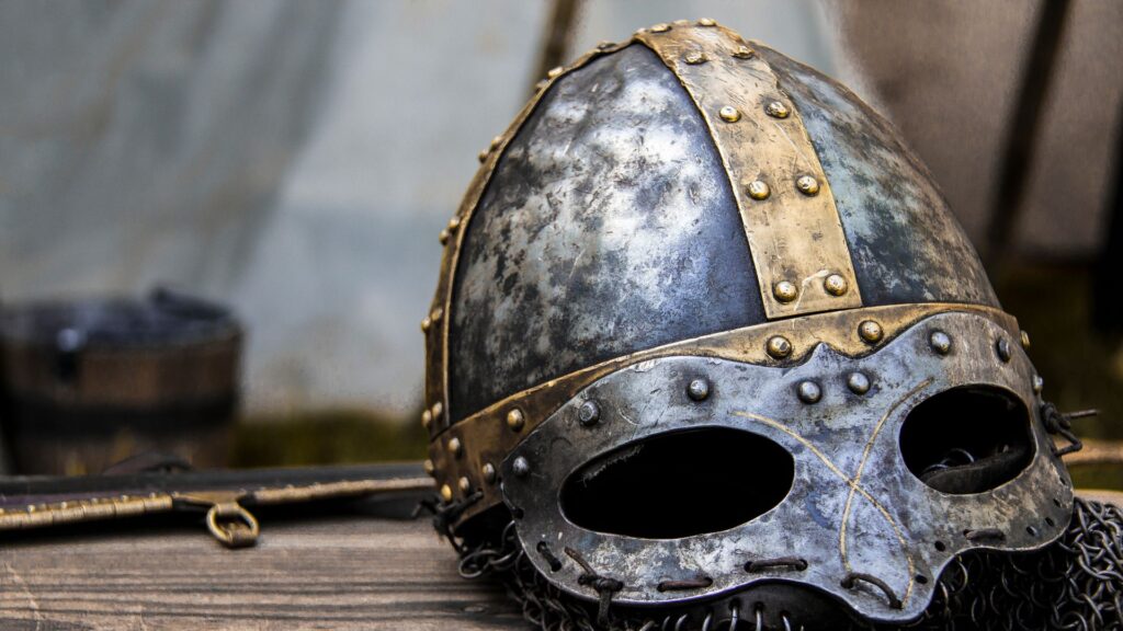 Medieval helmet on wooden background